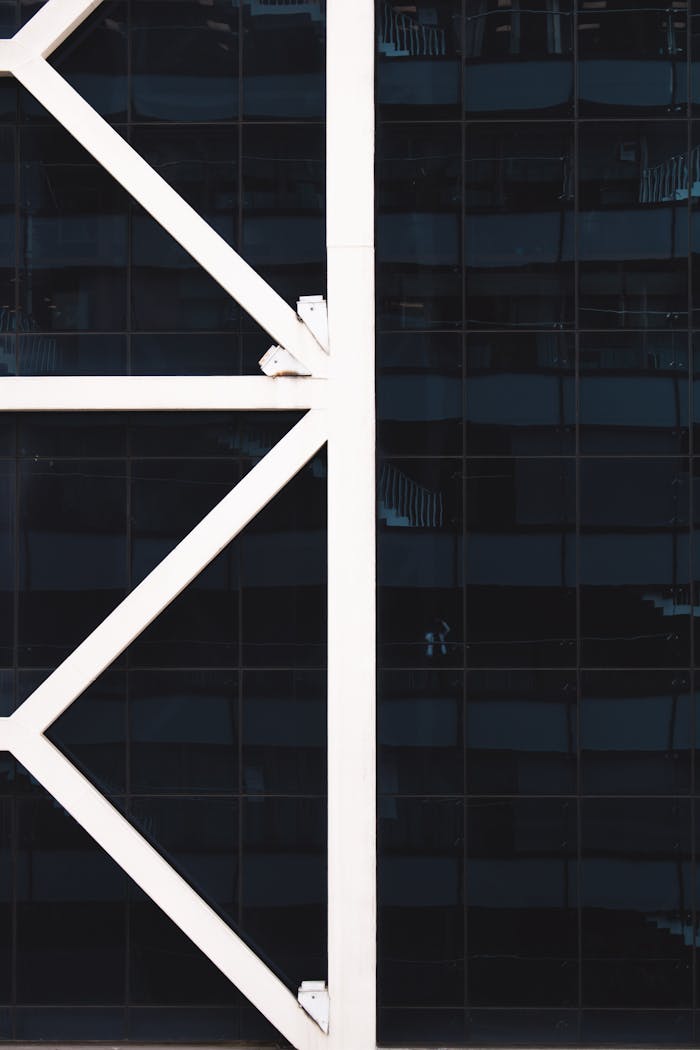 Contemporary architecture featuring glass facade and structural steel elements.